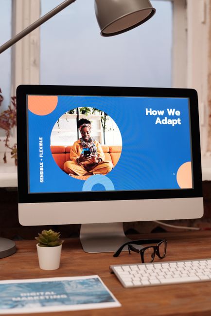 Creative office setup with a desktop computer displaying a vibrant design.